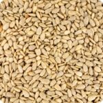 Sunflower hearts in spread out. Brown seeds that are heart shaped